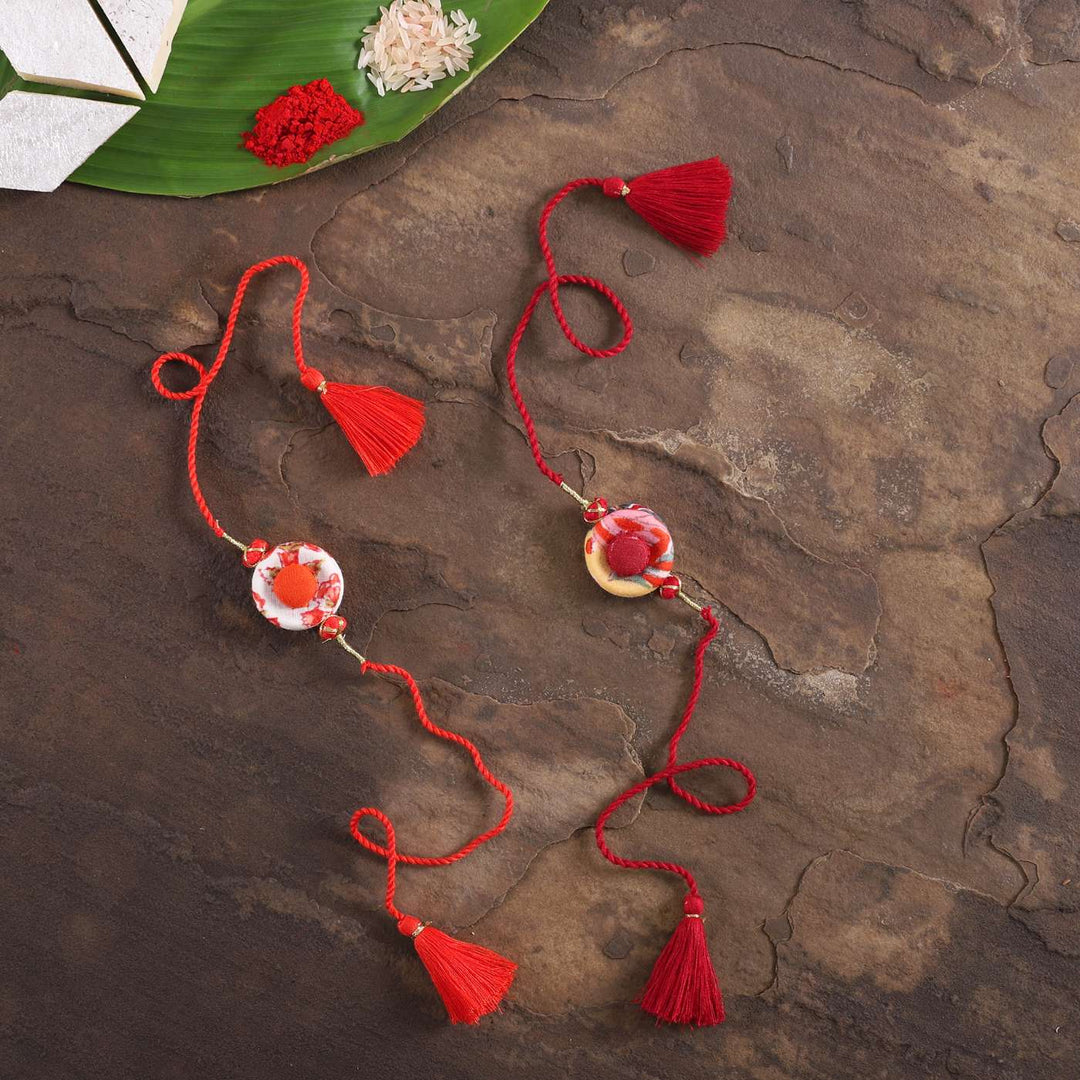 Handmade Ring Cotton Rakhi With Roli Chawal Set Of 2 - Full Length on Rustic Surface