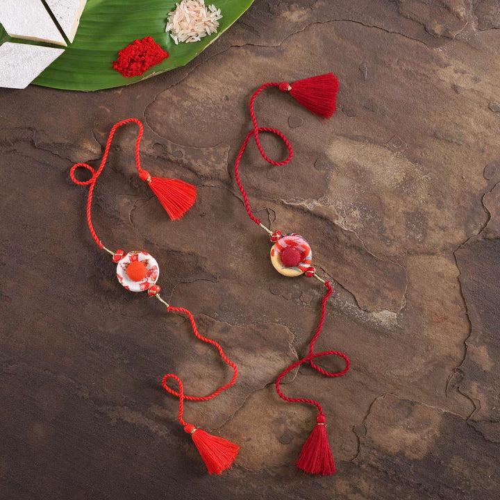 Handmade Ring Cotton Rakhi With Roli Chawal Set Of 2 - Full Length on Rustic Surface