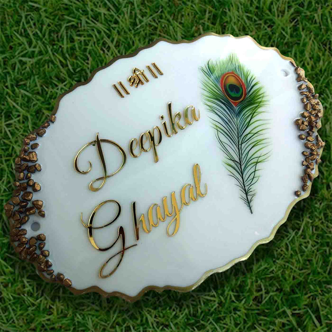 Personalized Handmade Peacock Feather Resin Name Plate - Top Angled View on Grass Background