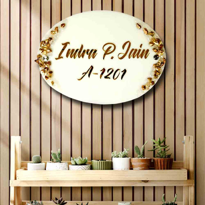 Personalized Handmade White And Gold Resin Name Plate - Mounted on Wall with Plants Below