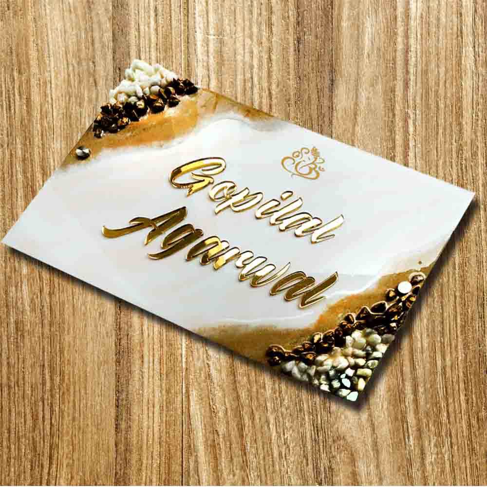 Personalized Handmade Ganesha Resin Name Plate - Angled Top-Down View on Floor