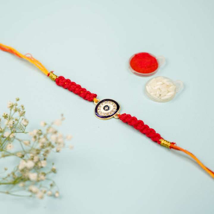 Customized Handmade Macrame Evil Eye Metal Rakhi With Roli Chawal - Flat lay with accessory items