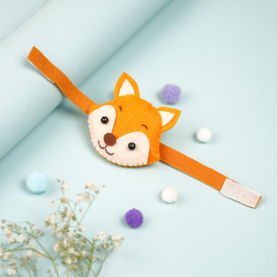 Handmade Fox Theme Felt Kids Rakhi With Roli Chawal - Front View with Decorative Pom-Poms