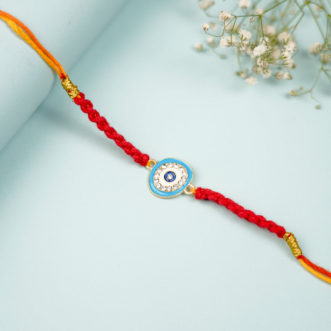 Customized Handmade Macrame Evil Eye Metal Rakhi With Roli Chawal - Close-up of middle charm