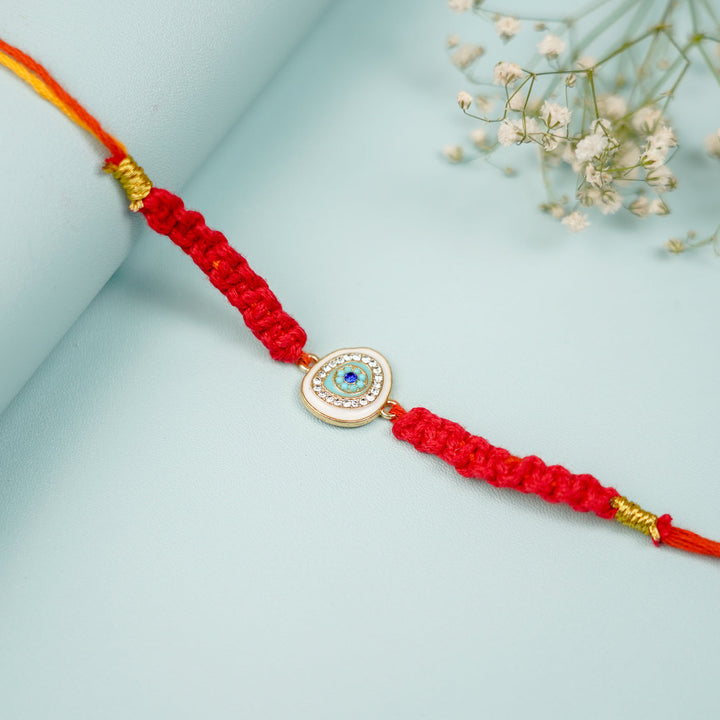 Customized Handmade Macrame Evil Eye Metal Rakhi With Roli Chawal - Close-up of eye charm