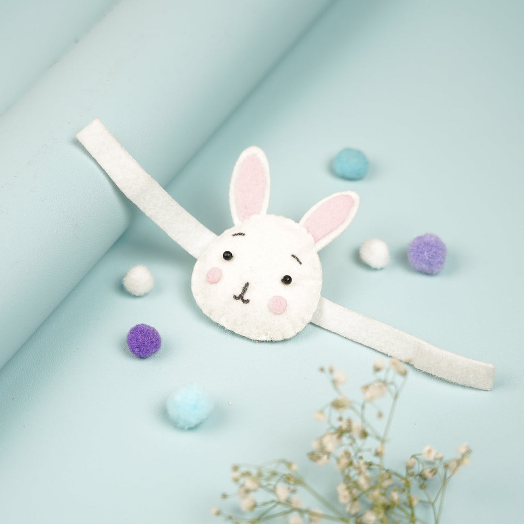 Handmade Bunny Theme Felt Kids Rakhi With Roli Chawal - Angled View with Decorative Items