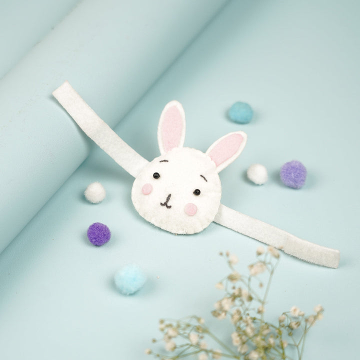 Handmade Bunny Theme Felt Kids Rakhi With Roli Chawal - Angled View with Decorative Items