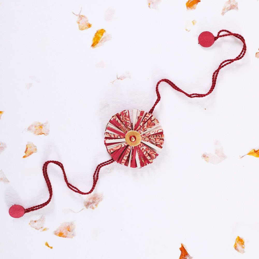 Handmade Ecofriendly Red Recycled Paper Rakhi With Roli Chawal - Flat Lay with Decorative Elements