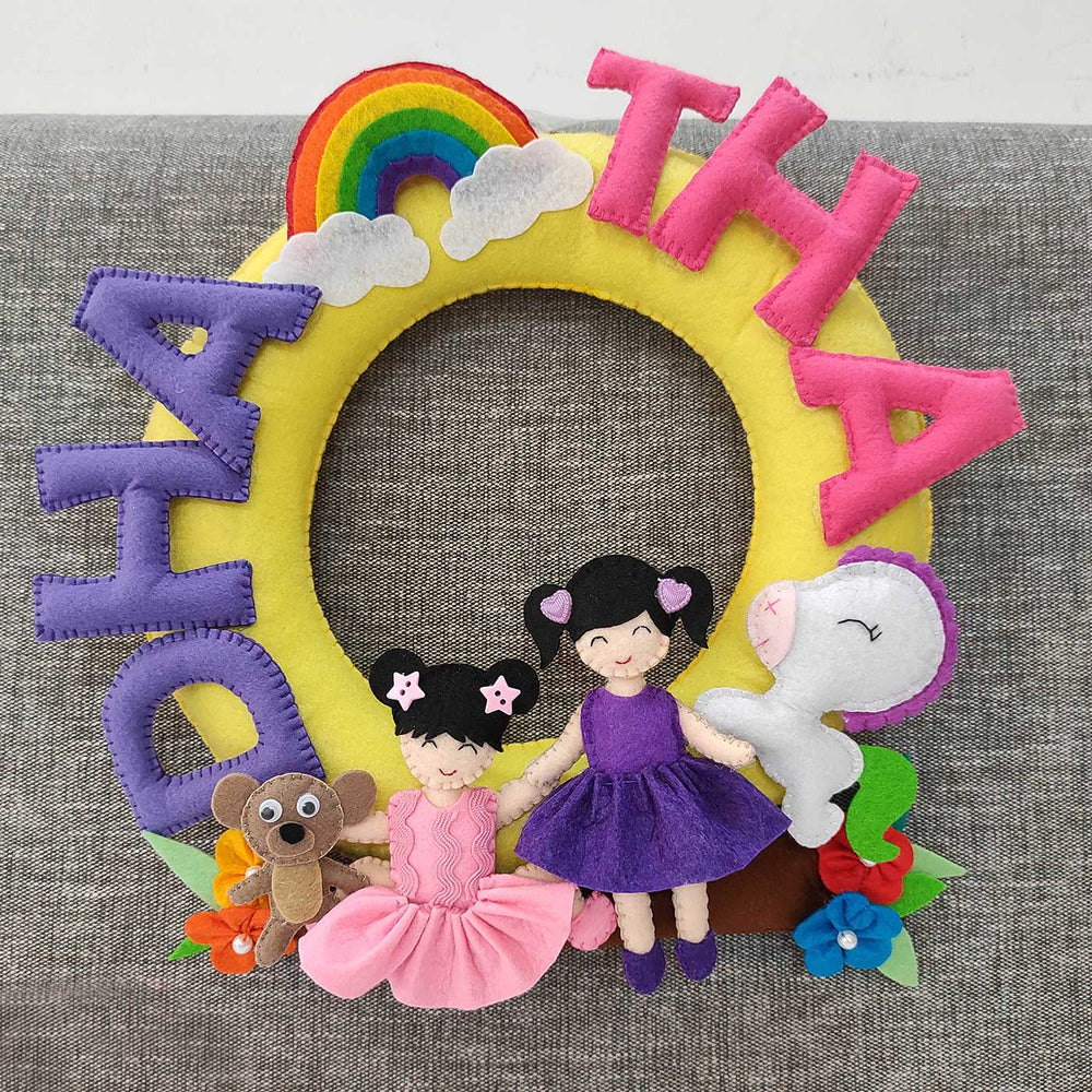 Personalized Handmade Round Sibling Felt Nameplate - Front View on Gray Sofa