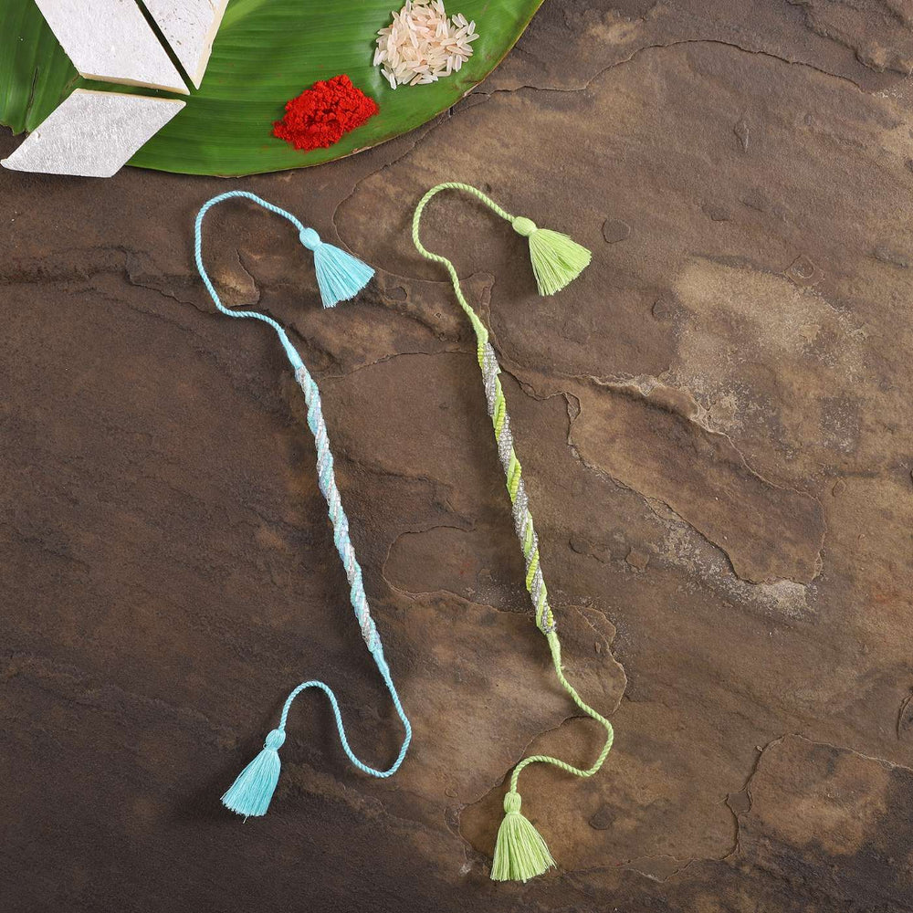 Handmade Beaded Zari Strings Rakhi With Roli Chawal Set Of 2 - Top View with Styled Props