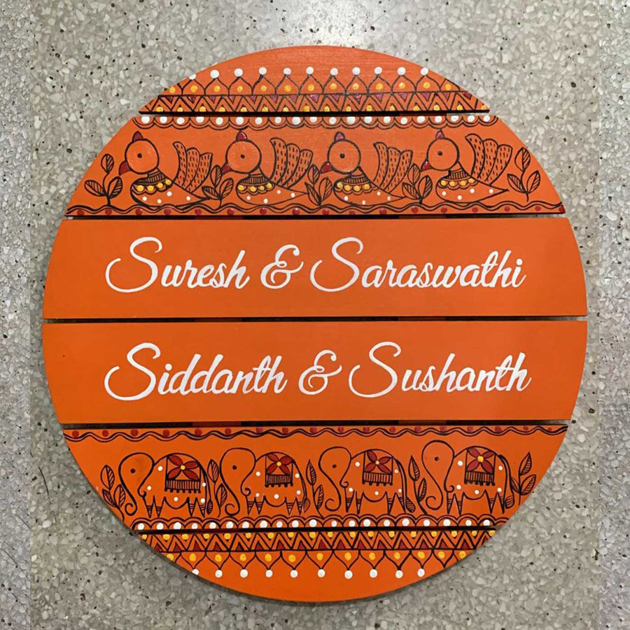 Ethnic Circle Name Plate In Orange - Top-down View of Personalized Names