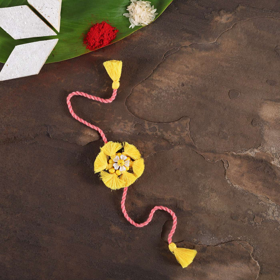 Handmade Beaded Tassel Flower Cotton Rakhi With Roli Chawal - Full View with Decor Elements