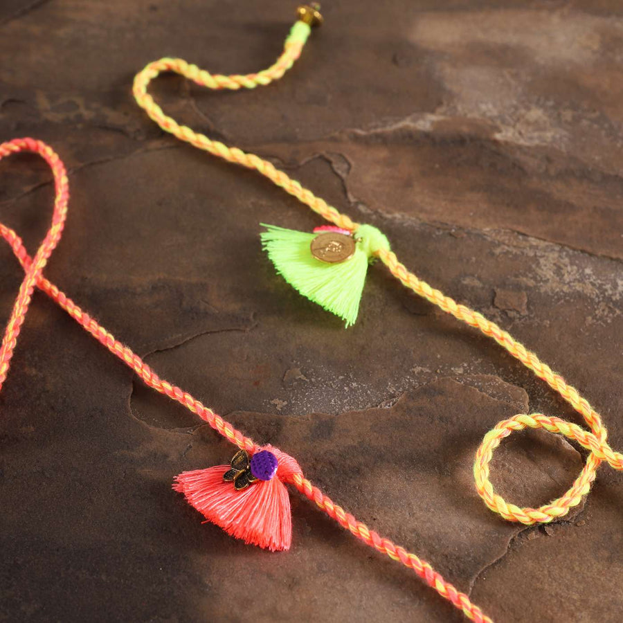 Handmade Coral And Green Tassel Rakhi With Roli Chawal Set Of 2 - Close-up of tassel details