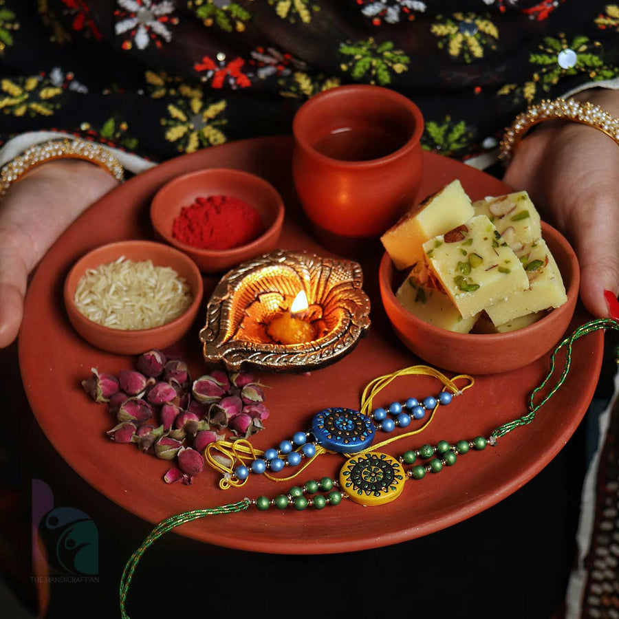 Handmade Ecofriendly Terracotta Rakhi Thali With Roli Chawal Set Of 7 - Held with festive items