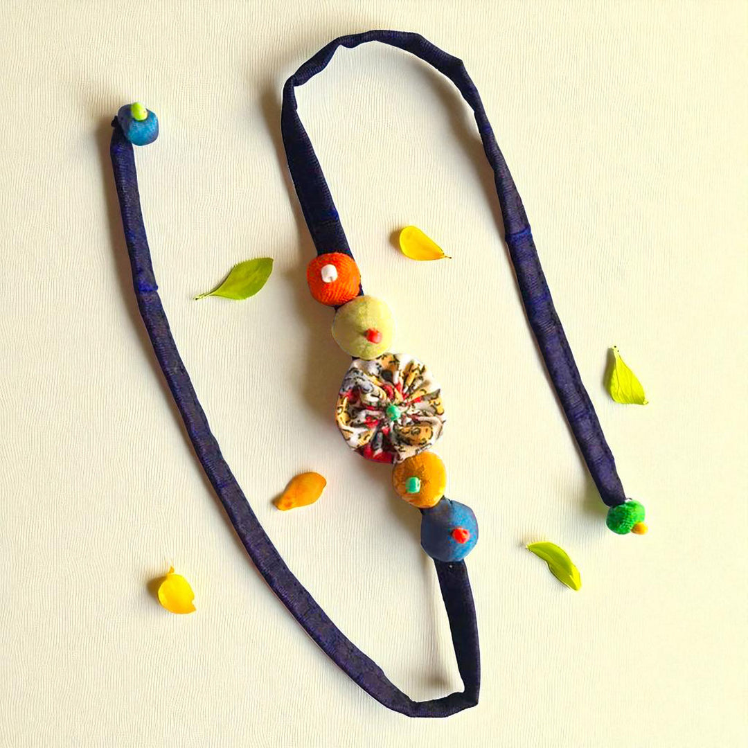 Handmade Beaded Shell Design Upcycled Fabric Rakhi With Roli Chawal For Brother - Flat lay of full accessory