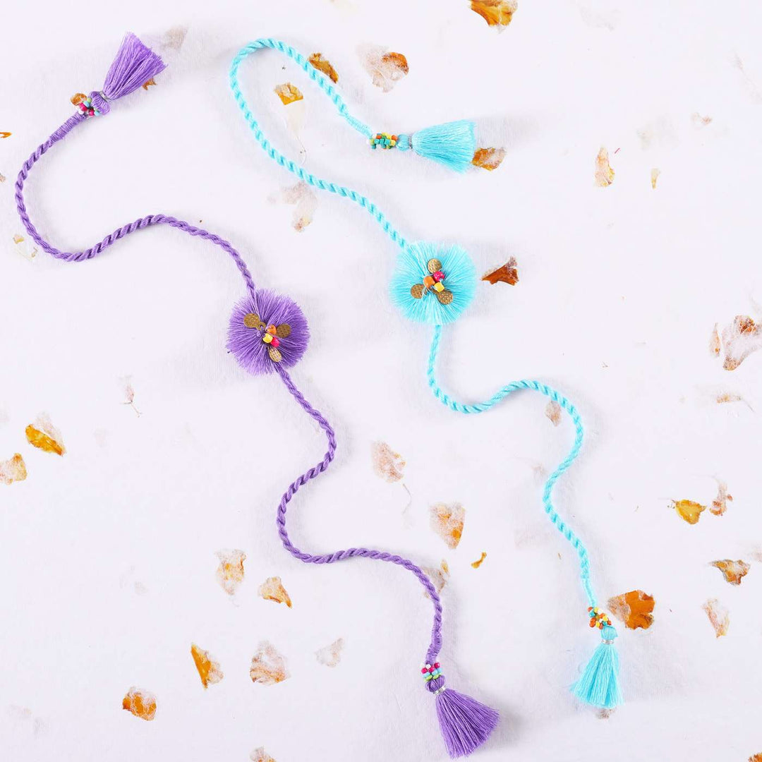Handmade Threads Cotton Rakhi With Roli Chawal Set Of 2 - Styled on White Marble Background