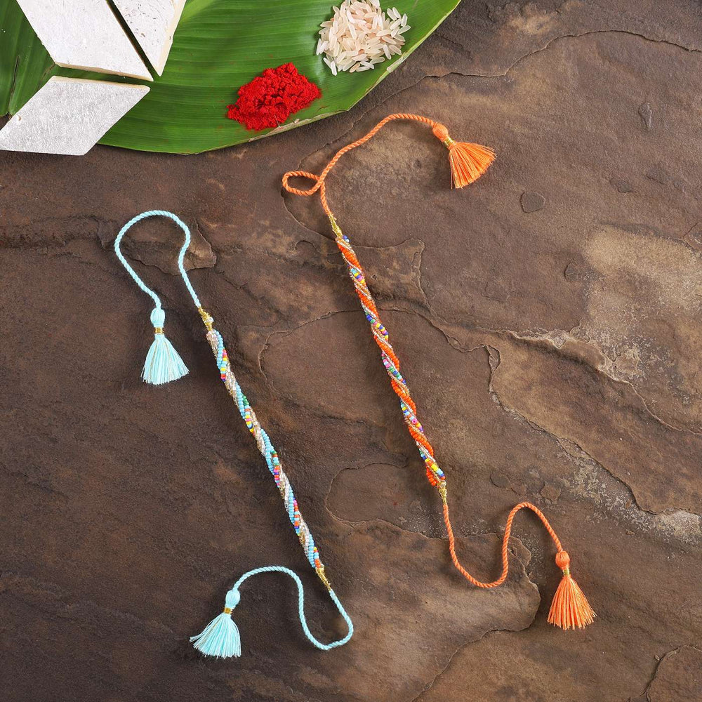 Handmade Beaded Twister Rakhi With Roli Chawal Set Of 2 - Flat Lay with Decorative Props