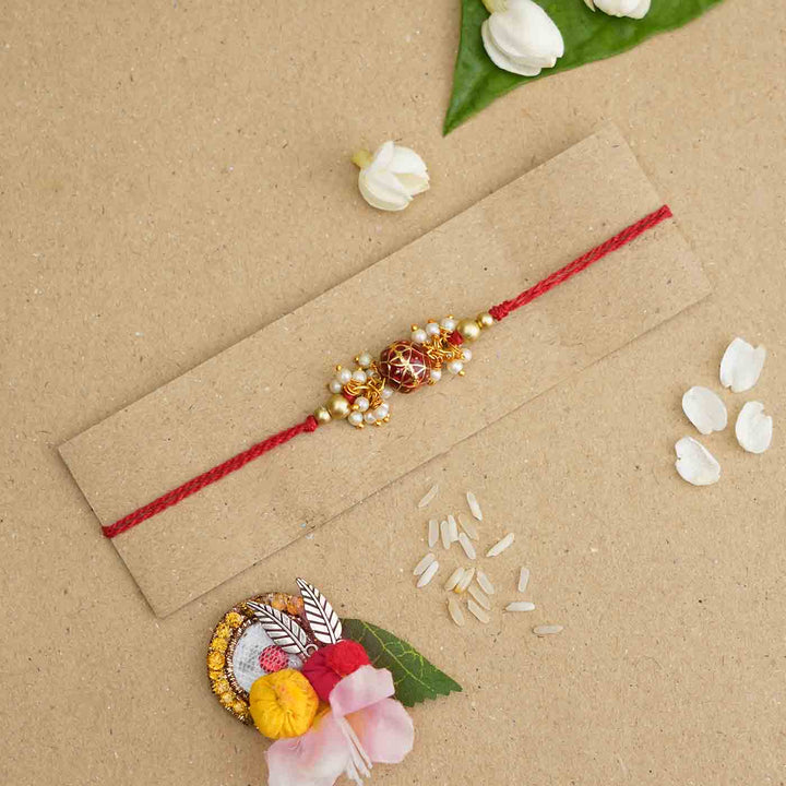 Handmade Red Meena Bead Pearl Rakhi With Roli Chawal - Rakhi on cardboard display