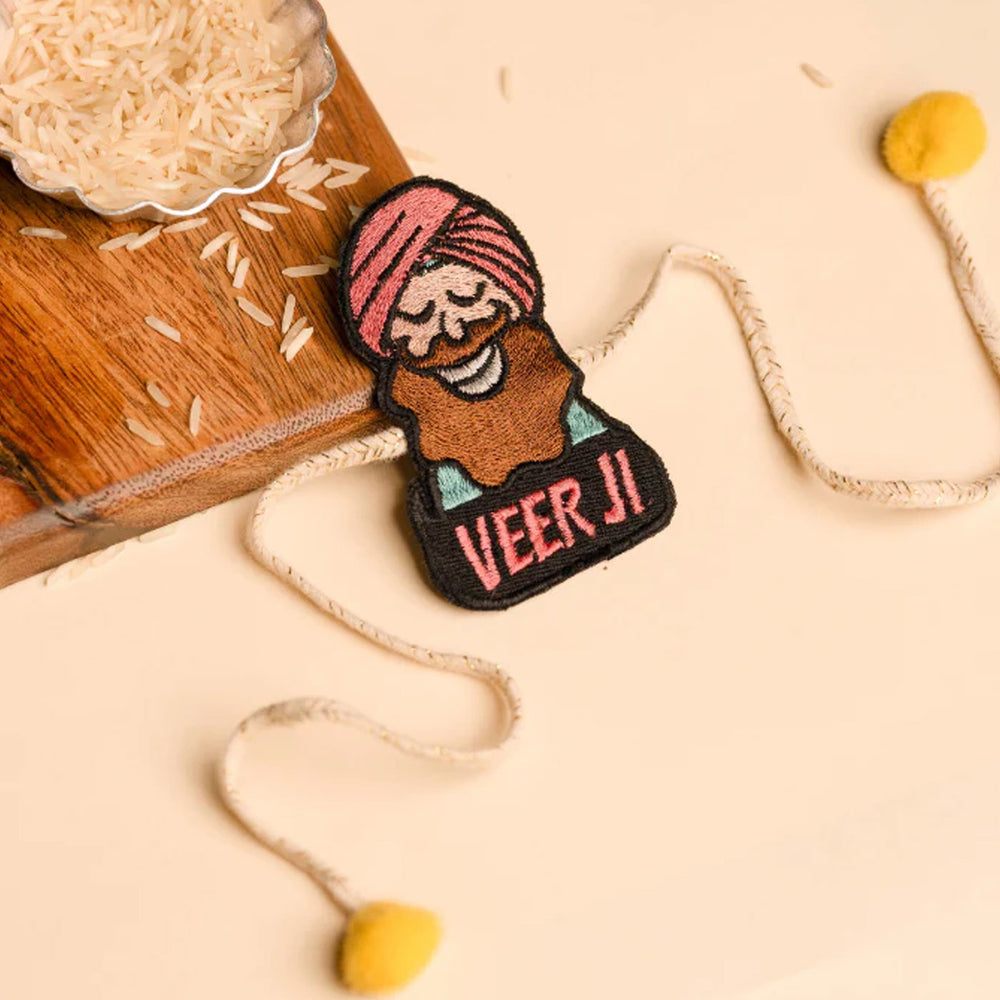 Handmade Punjabi Veer Ji Felt Rakhi For Brother - Flat Laying with Rice Grains