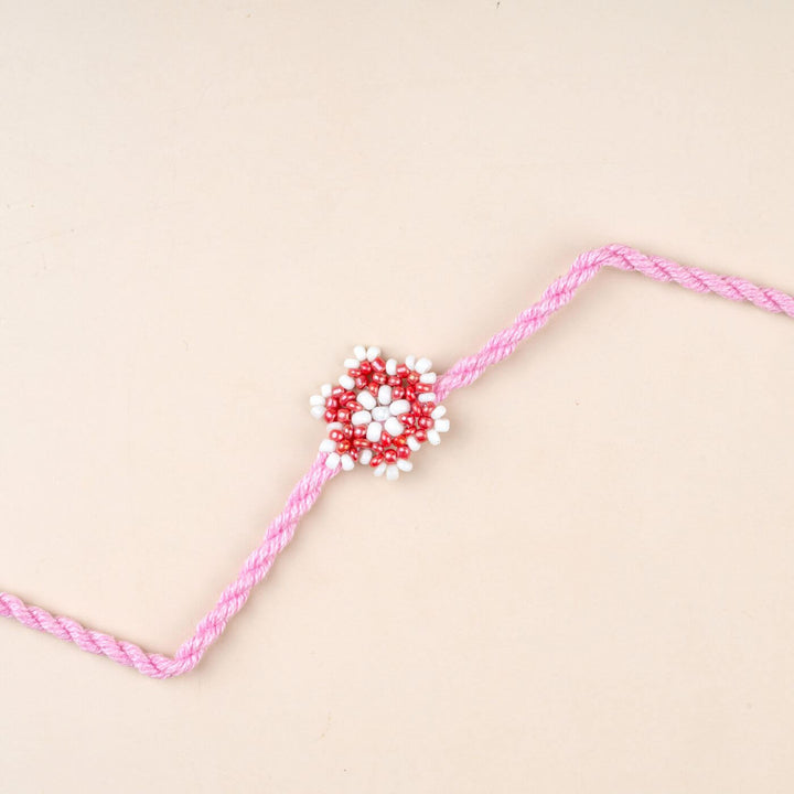 Handcrafted Glass Beads Sitara Rakhi 7 - Close-up of pink rakhi design