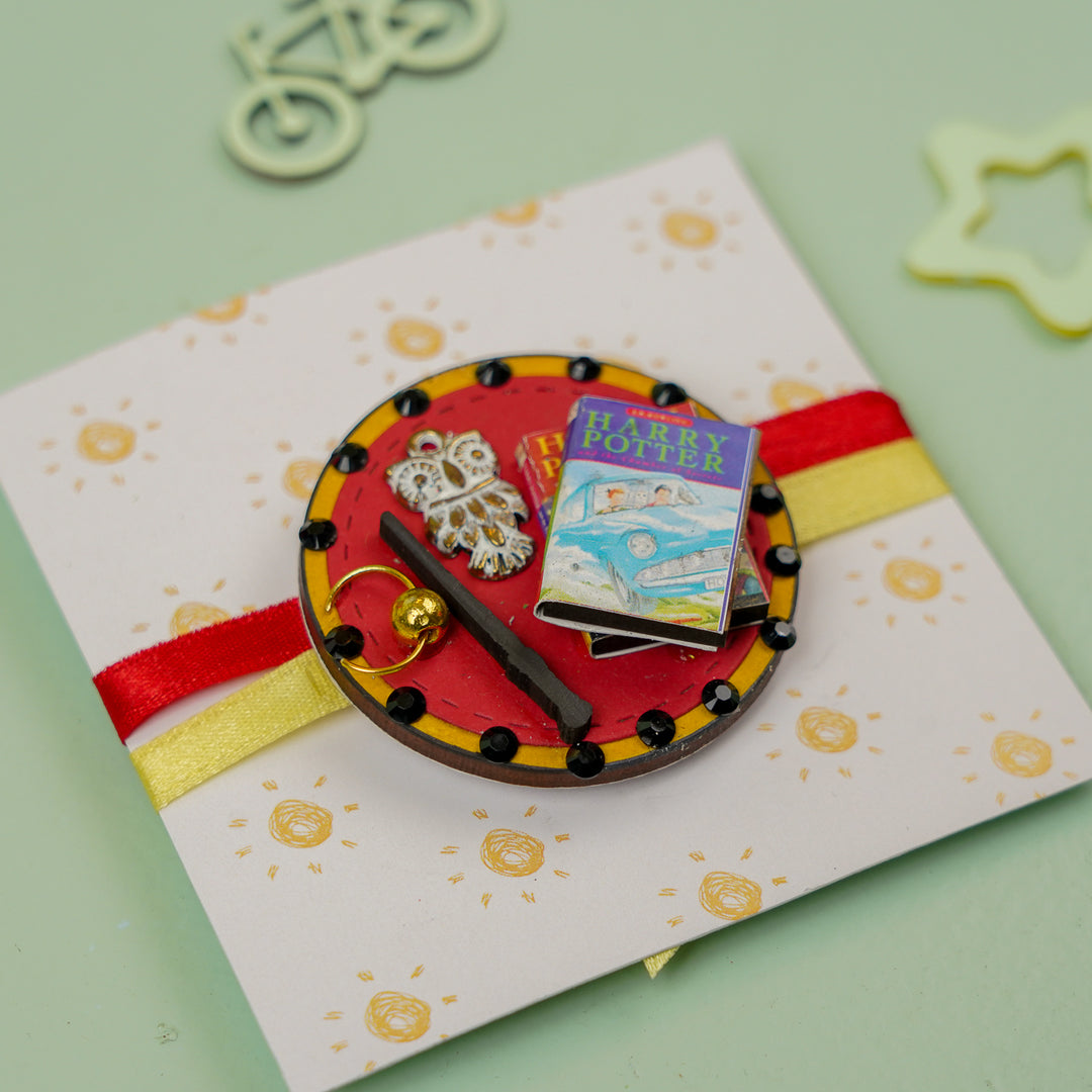 Handmade Harry Potter 3D Elements Mdf Wood Kids Rakhi With Roli Chawal - Angled View with Background Props