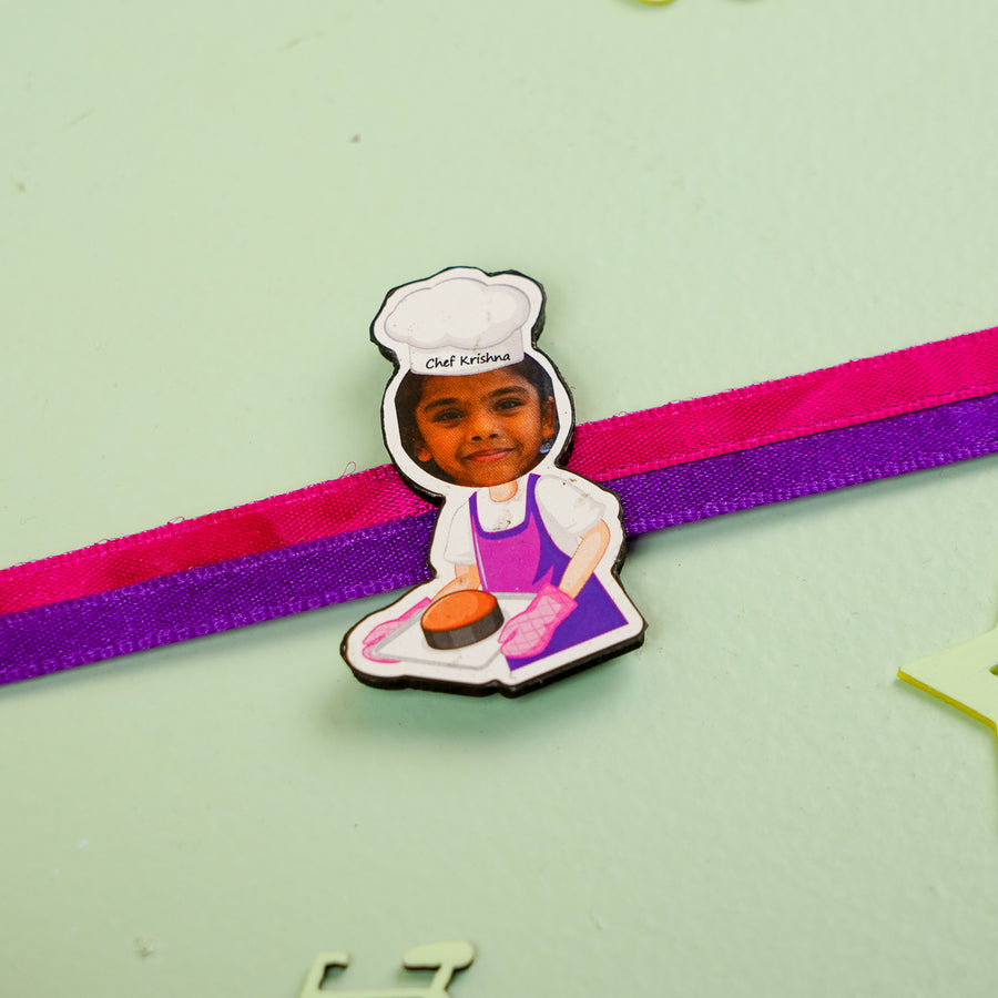Photo Personalized Handmade Reusable Caricature Girl Chef Mdf Wood Kids Rakhi With Roli Chawal - Close-up of Chef Character Charm