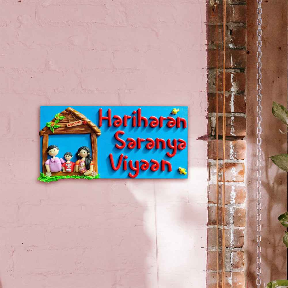 Handcrafted Personalized Clay Caricature Family Name Plate - Mounted on Pink Wall Close-up