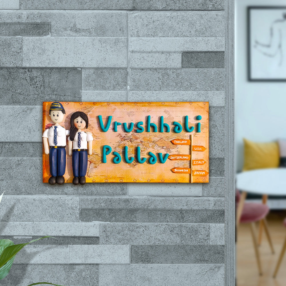 Handcrafted Personalized Clay Caricature Name Plate For Pilot Couples - Mounted on Gray Brick Wall