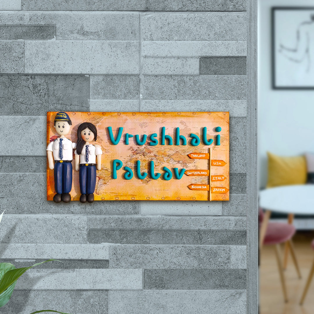 Handcrafted Personalized Clay Caricature Name Plate For Pilot Couples - Mounted on Gray Brick Wall