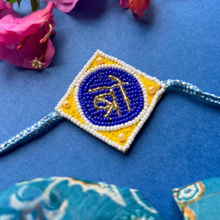 Handmade Beaded Bro Rakhi With Roli Chawal - Rakhi on Decorative Background