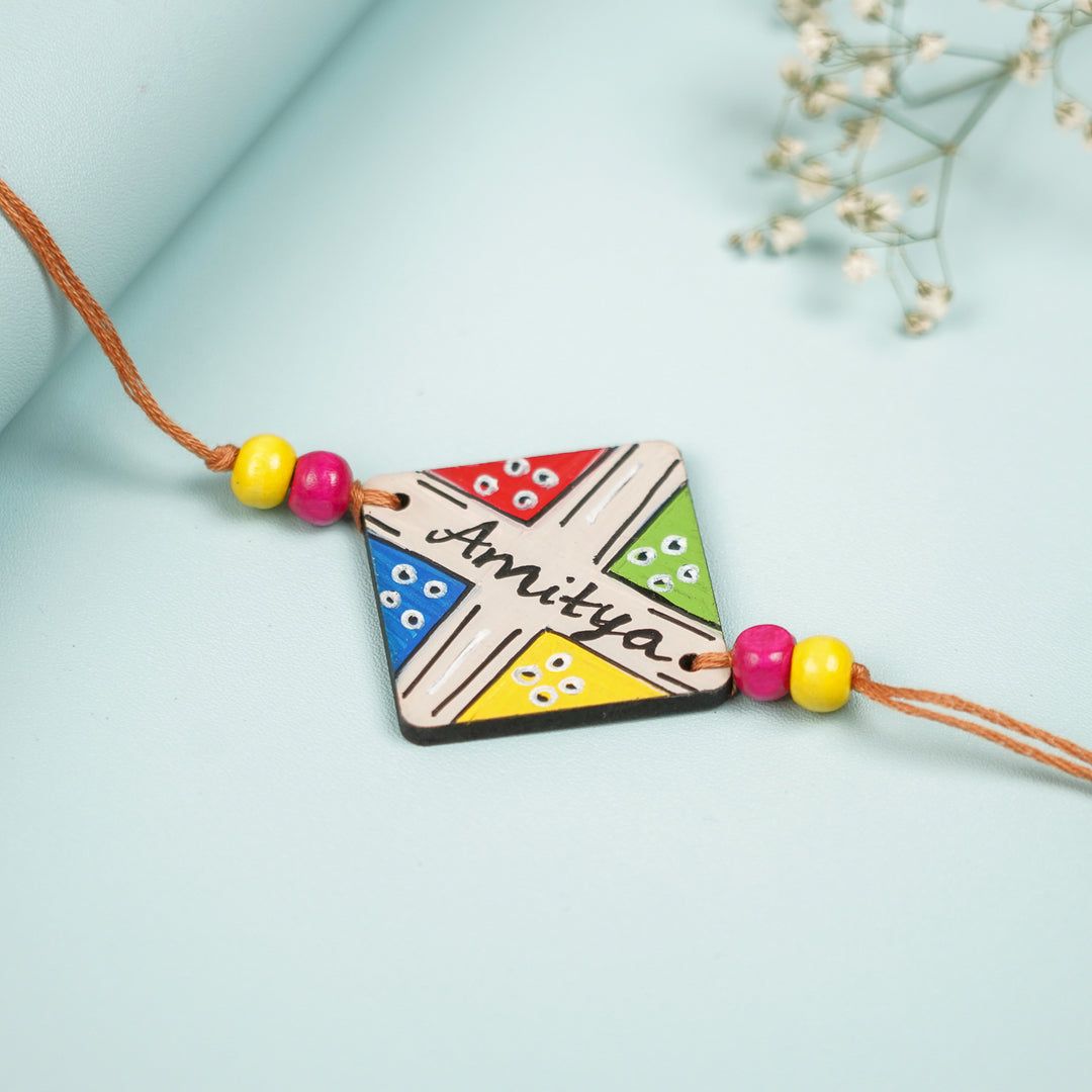 Personalized Hand Painted Ludo Design Mdf Wood Rakhi - Angled Front View Showing Details