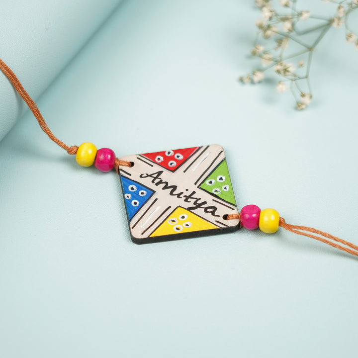 Personalized Hand Painted Ludo Design Mdf Wood Rakhi - Angled Front View Showing Details
