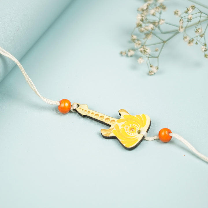 Customized Hand Painted Dot Mandala Guitar Design Mdf Wood Rakhi - Close-up Side View with Orange Beads