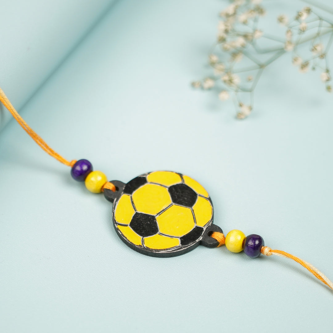 Hand Painted Football Design Mdf Wood Kids Rakhi - Close-up on Flat Surface