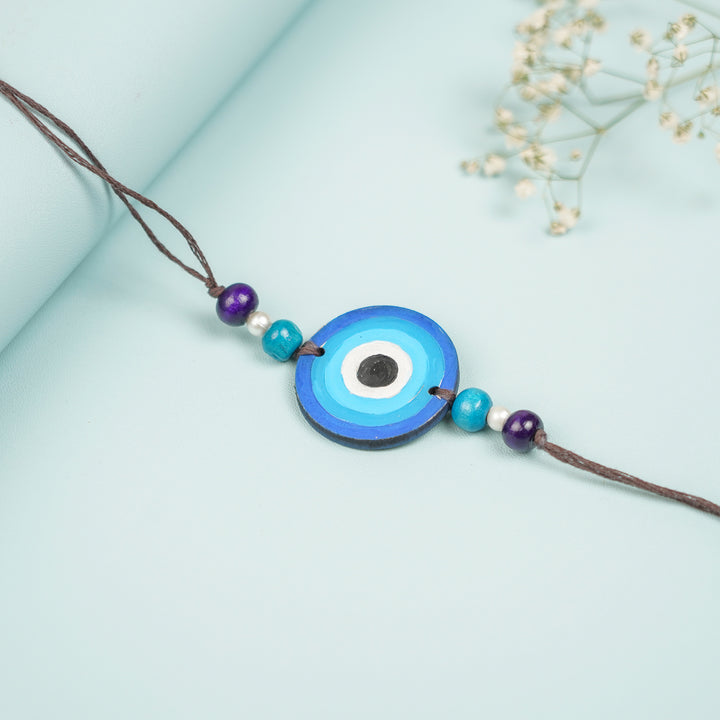 Customized Hand Painted Evil Eye Design Mdf Wood Rakhi - Close-up on Round Pendant with Beads