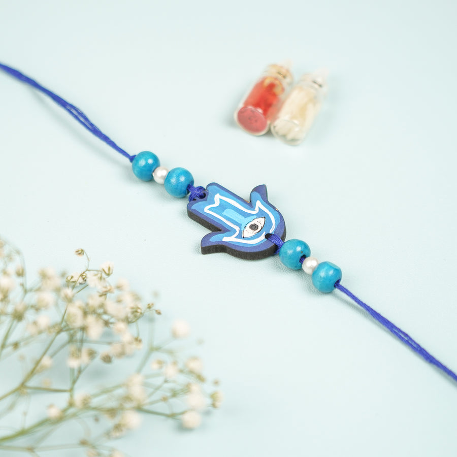Customized Hand Painted Hamsa Hand Design Mdf Wood Rakhi - Front View with Decorative Bottles
