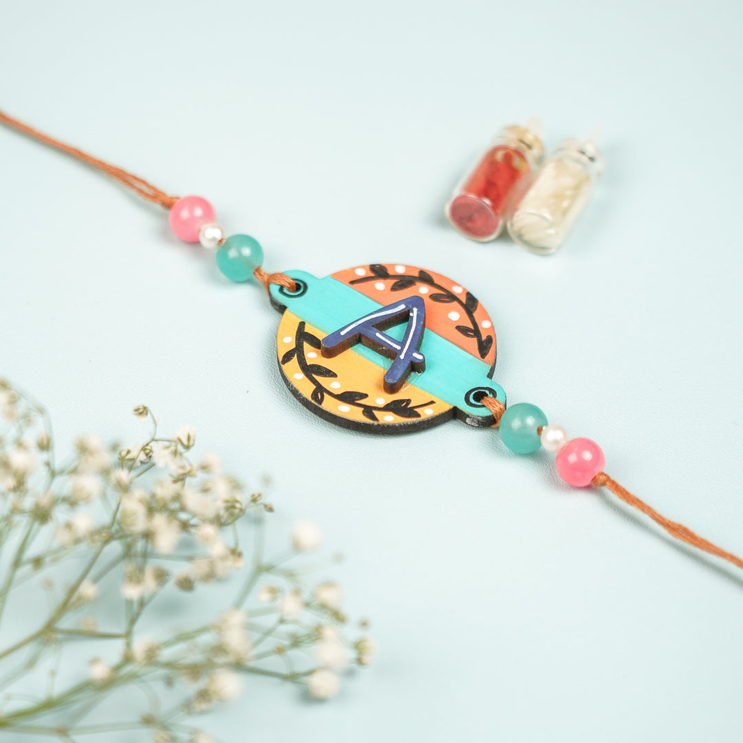 Personalized Hand Painted Layered Monogram Design Mdf Wood Rakhi - Front View