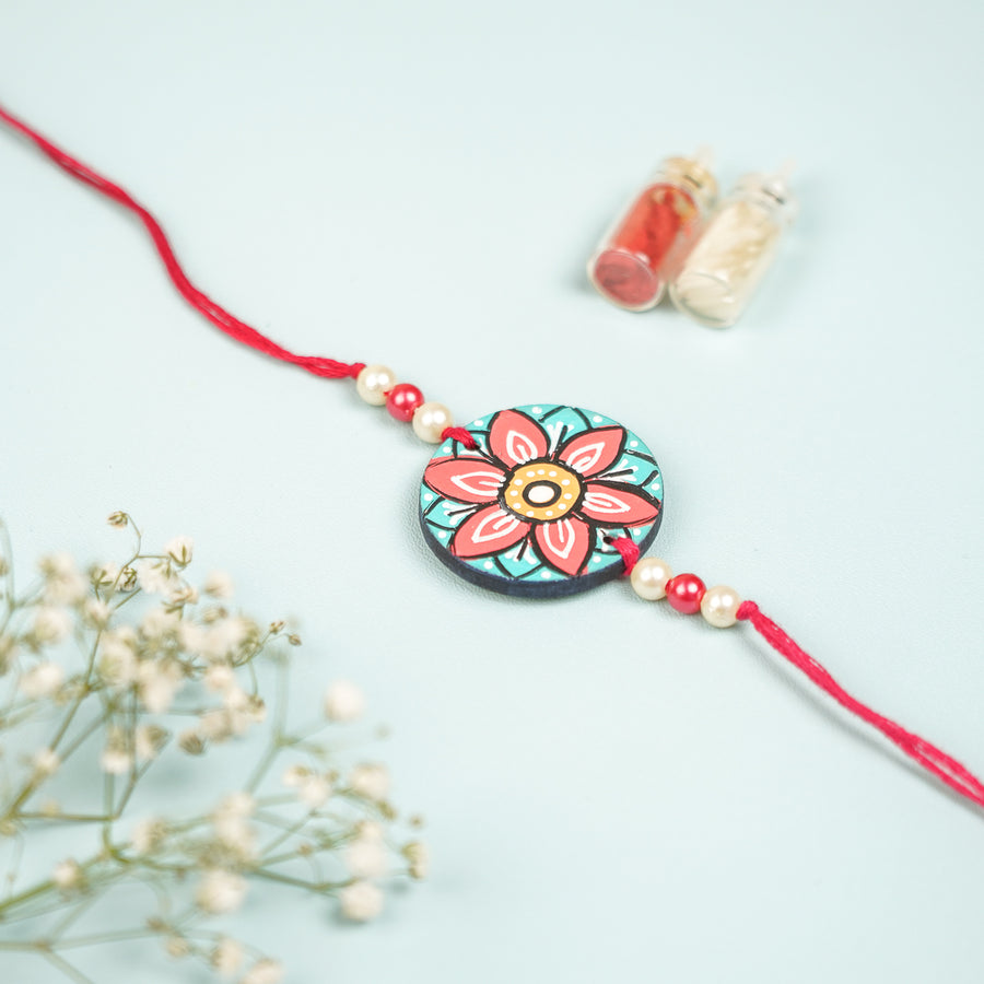 Customized Hand Painted Mandala Design Mdf Wood Rakhi - Front View with Decorative Background