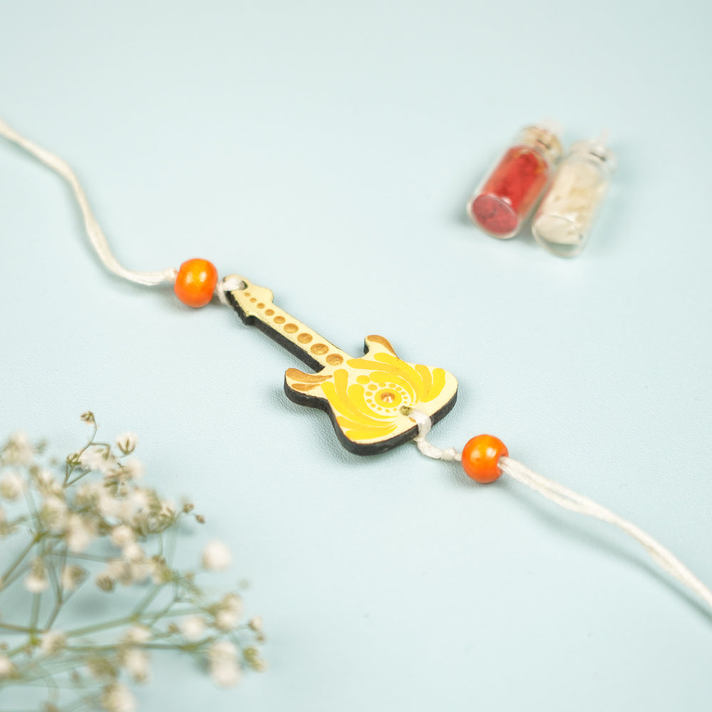 Customized Hand Painted Dot Mandala Guitar Design Mdf Wood Rakhi - Front View with Orange Beads