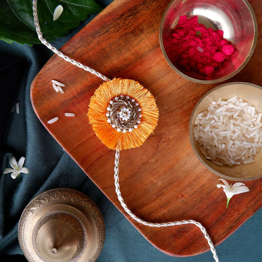 Handmade Zardozi Mustard And White Bead Work Rakhi With Wooden Box And Roli Chawal - Close-up on Rakhi design