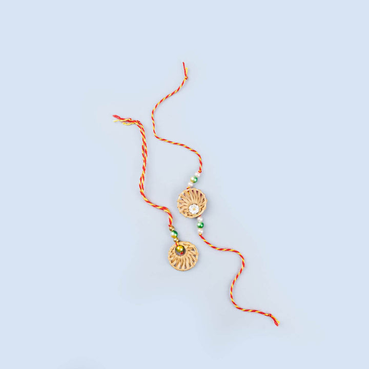 Ecofriendly Bamboo Rakhis For Bhaiya Bhabhi With Roli Chawal 3 - Pair of rakhis laid flat