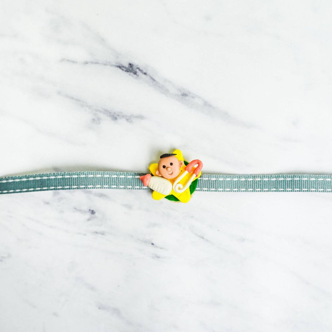 Handmade Porcelain Clay Themed Rakhi 4 - Baby Rakhi Front View