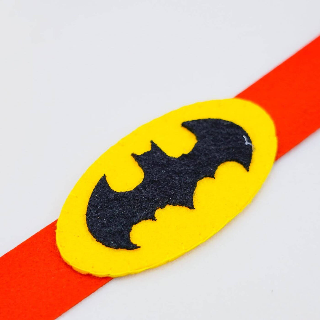 Kids Theme Felt Rakhi Band With Roli Chawal 5 - Close-up of Batman symbol