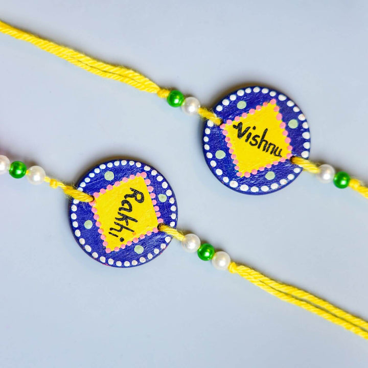 Personalized Terracotta Tumbler Rakhi Set With Caricature - Close-up of Rakhi Name Details