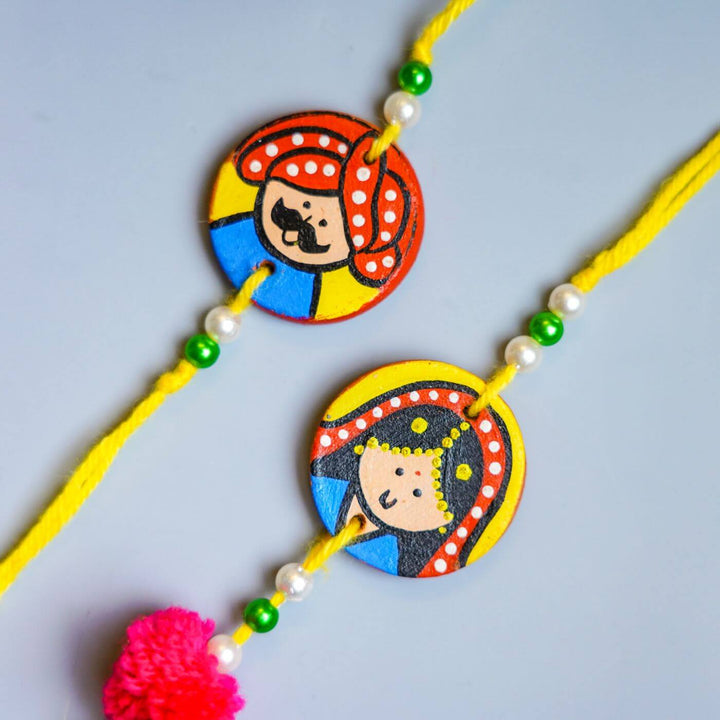 Personalized Terracotta Mug Rakhi Set With Caricature - Close-up of Rakhi Faces