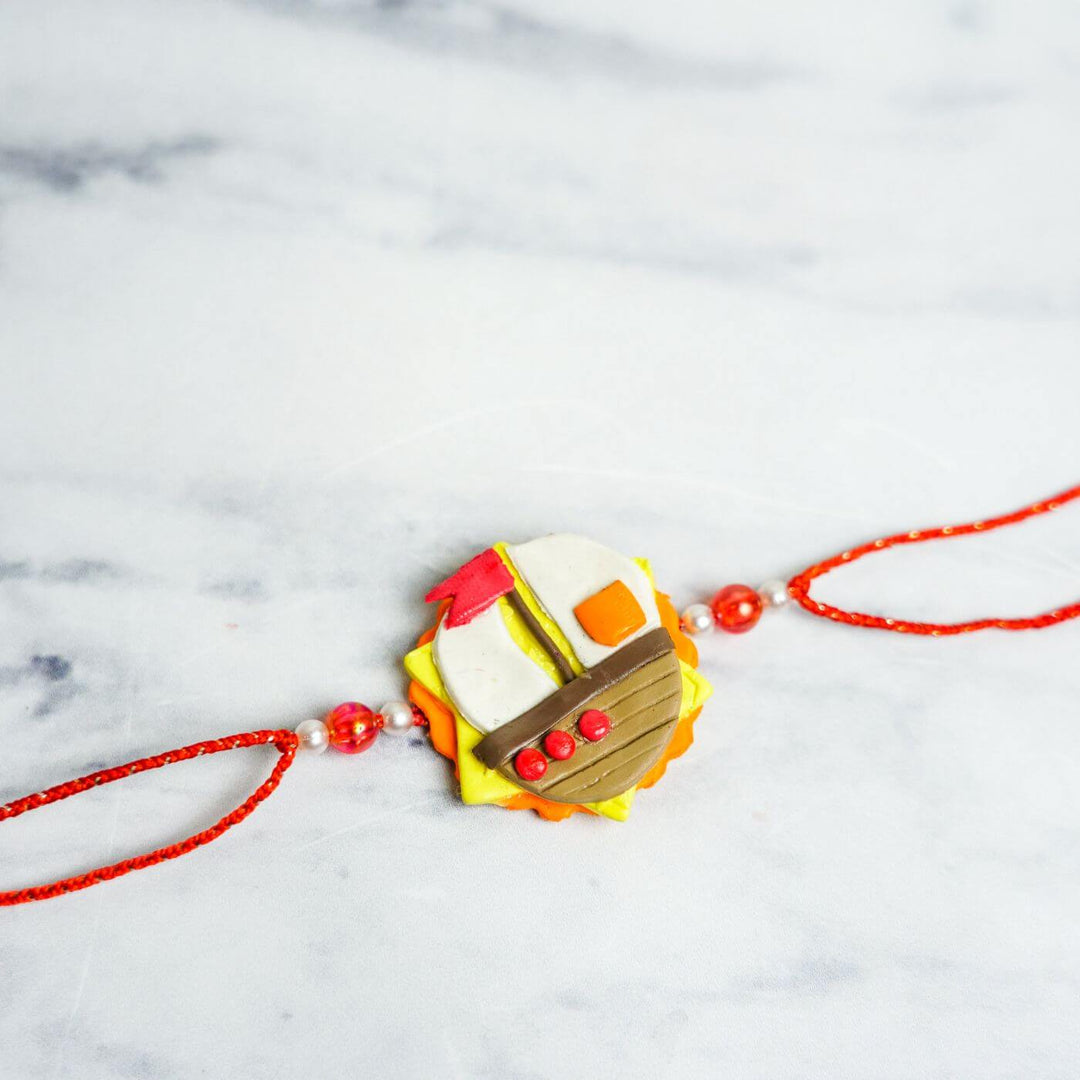 Handmade Porcelain Clay Themed Rakhi 11 - Front view of Rakhi with beads