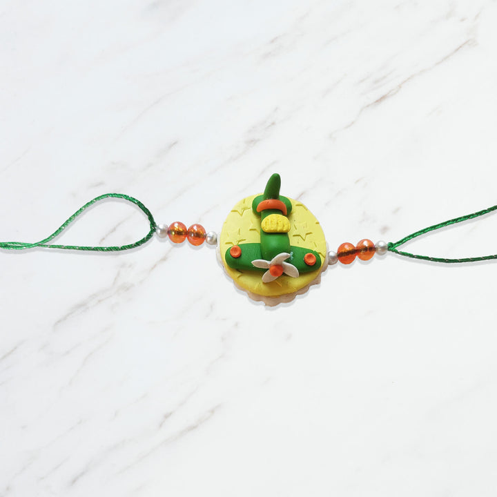 Handmade Porcelain Clay Themed Rakhi 10 - Front View with Green Strap