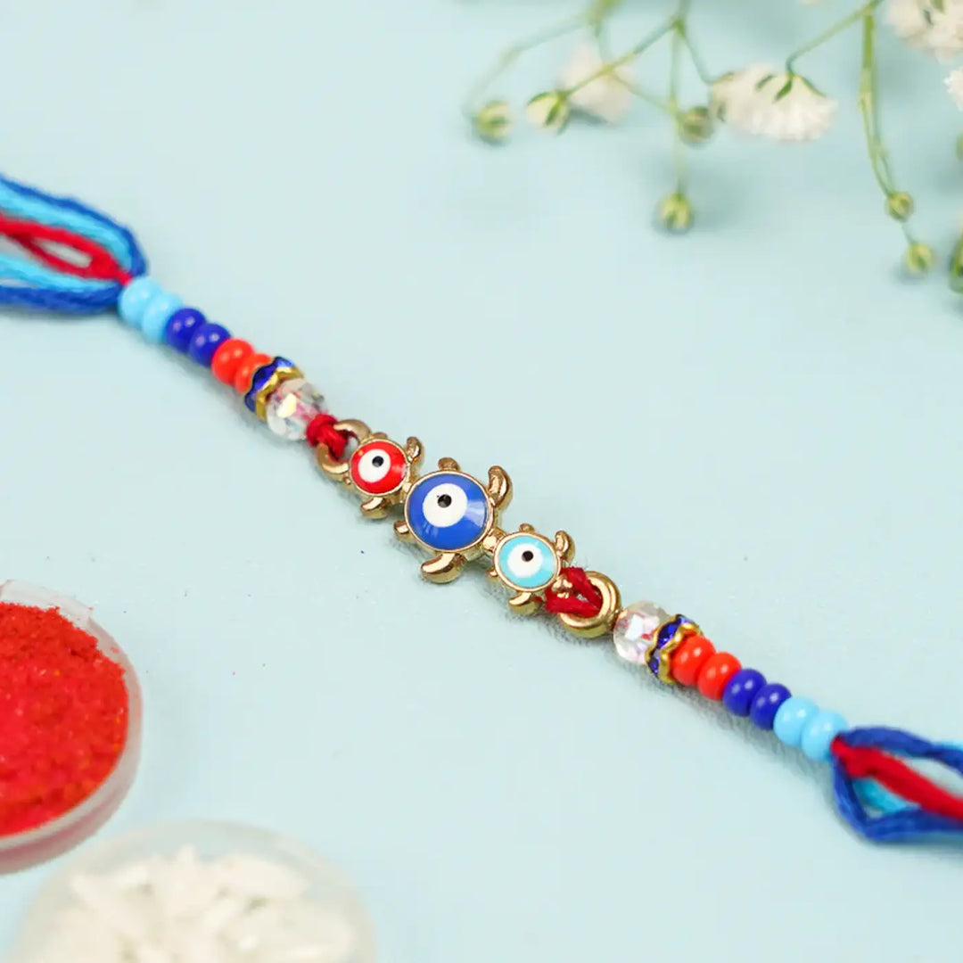 Handmade Beaded Turtle Evil Eye Rakhi With Roli Chawal - Close-up of Rakhi Detail