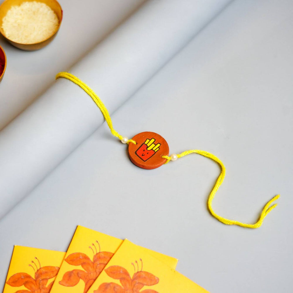 Personalized Food Theme Terracotta Rakhi With Roli Chawal 4 - Styled Flat Lay with Gift Envelopes