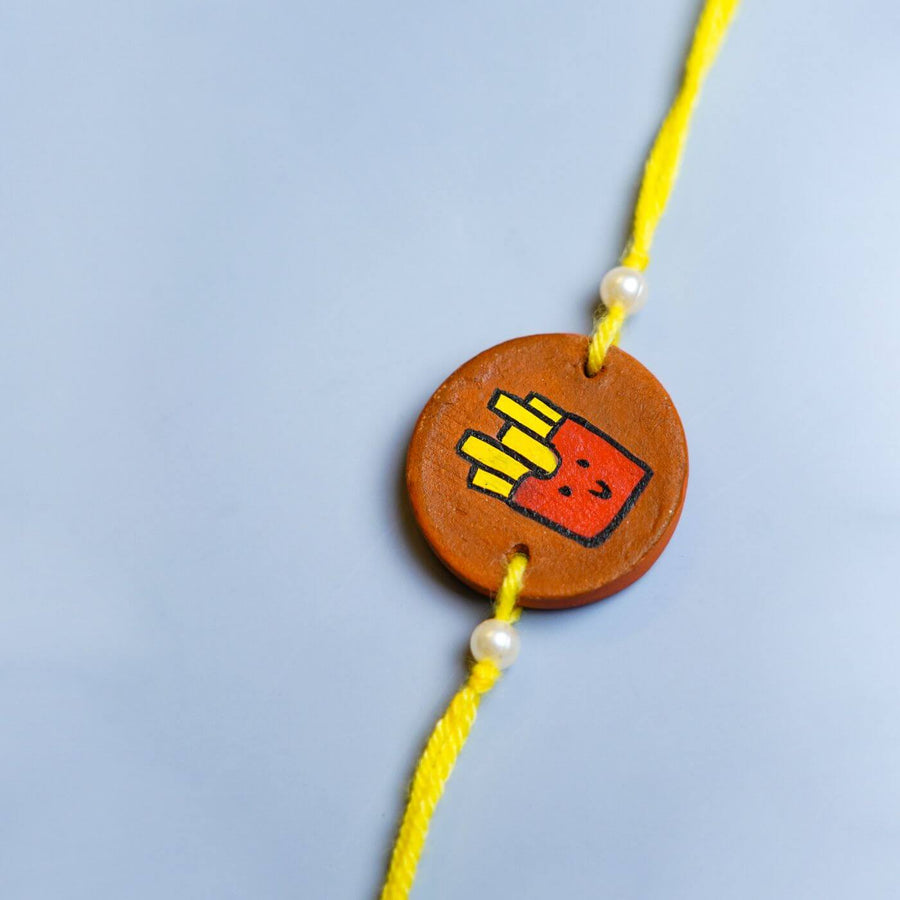 Personalized Food Theme Terracotta Rakhi With Roli Chawal 4 - Close-up of Decorative Pendant